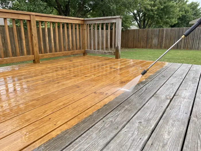 Wooden deck mid-clean, weathered grey boards beside freshly washed honey-brown boards