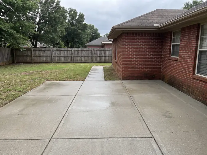 The same patio after pressure washing, the concrete a clean even grey